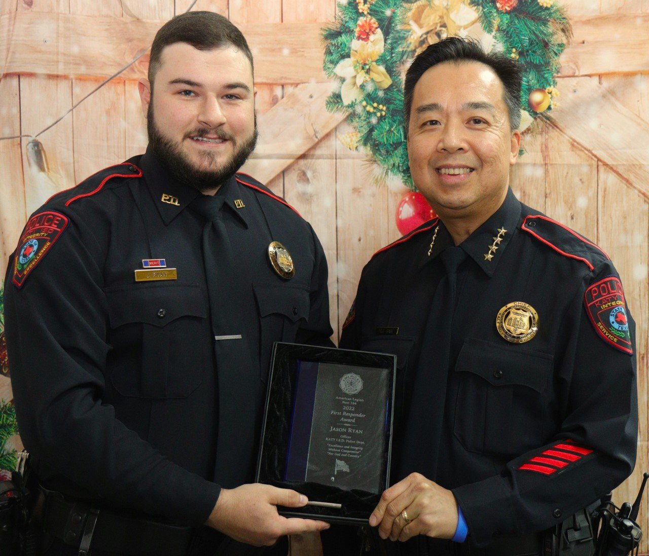 Katy ISD Police officer Jason Ryan receives congratulations from Katy ISD Police Chief Henry Gaw at the American Legion Post 164 First Responders Dinner, held Dec. 10 at the Elks Lodge, 1050 Katy Fort Bend Road.